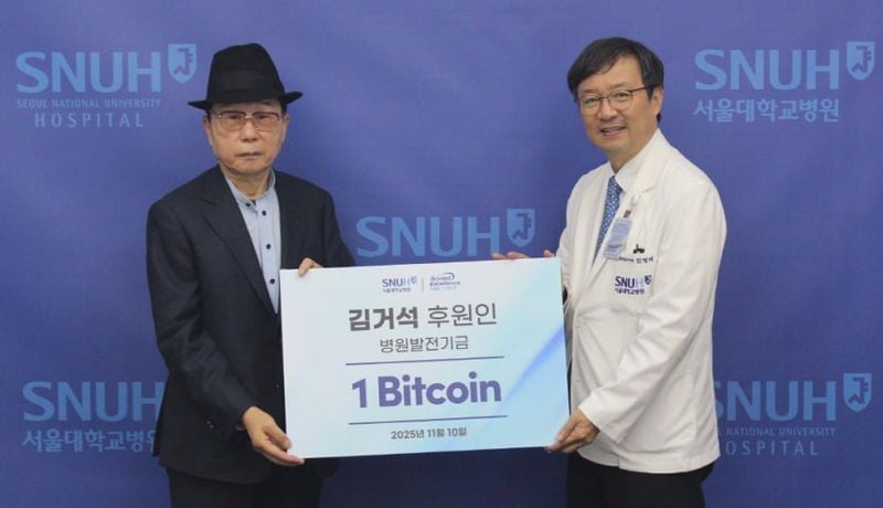 개인 투자자 김거석 씨(왼쪽)가 10일 서울 종로구 연건동 서울대병원에서 열린 기부금 전달식에서 김영태 서울대병원장에게 기부 금액이 적힌 팻말을 전달하고 있다.[사진제공  서울대병원]